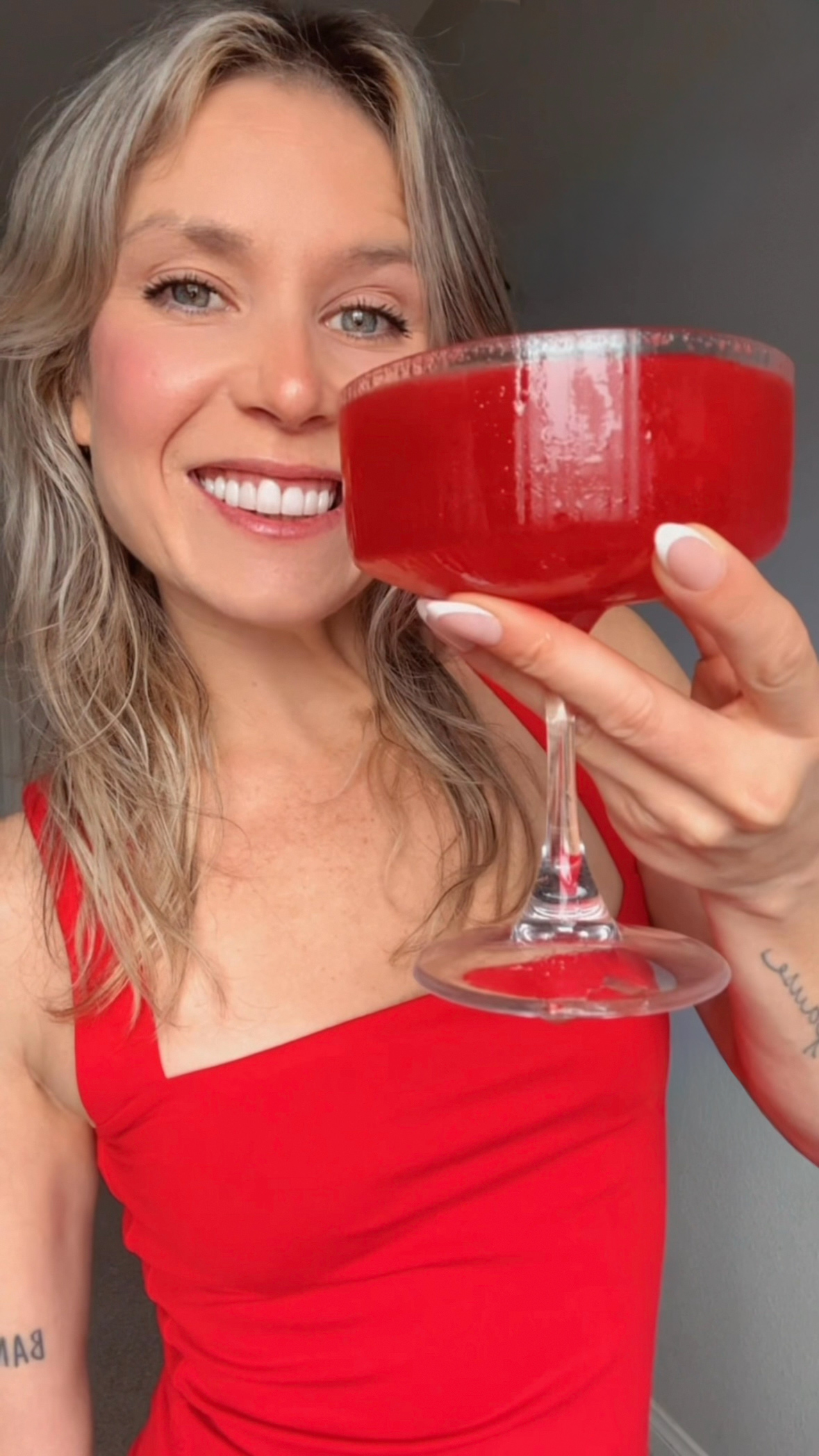 Claire Scott from Claire bear bites holding a strawberry cocktail