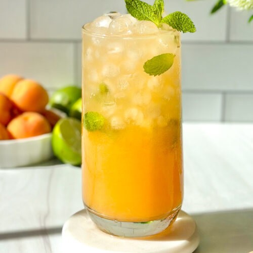 Refreshing apricot mojito served over ice and garnished with fresh mint