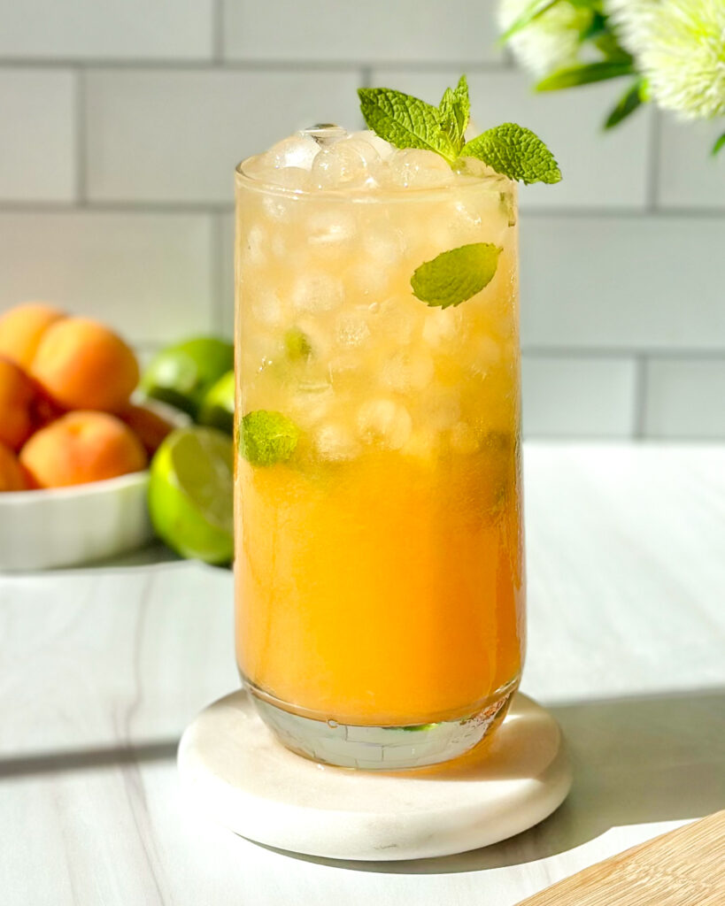 Refreshing apricot mojito served over ice and garnished with fresh mint