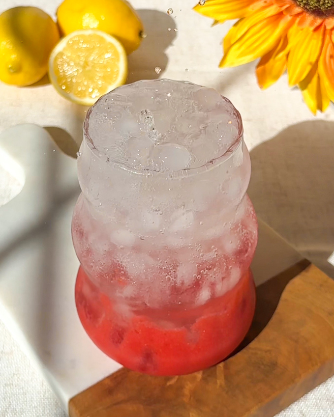 bubbling soda water in frosty glass for homemade strawberry electrolyte drink