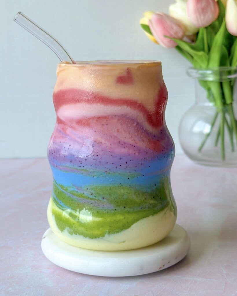 hero image of finished and swirled layered rainbow smoothie thats all natural and dye free