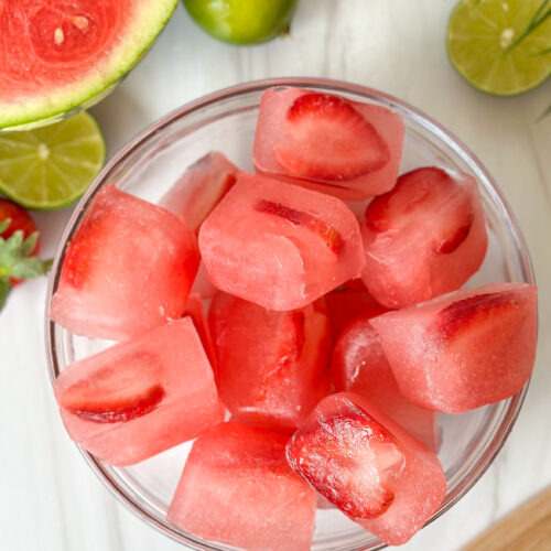 overhead shot of watermelon strawberry ice cubes in a bowl