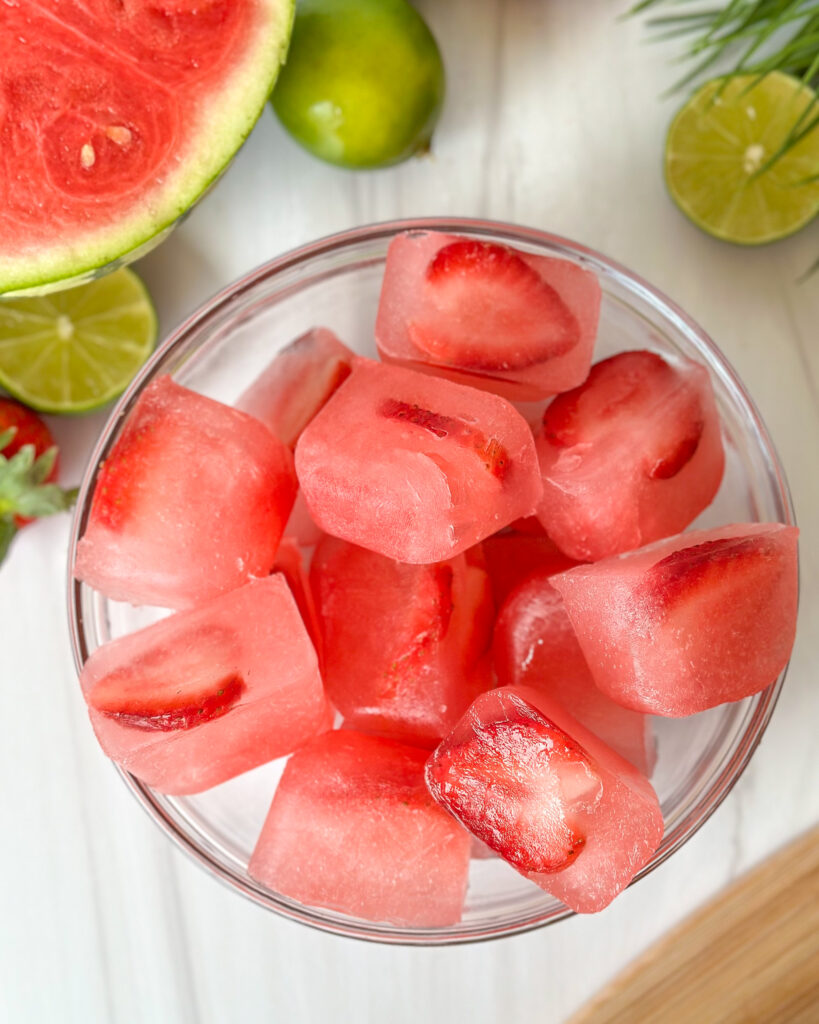 overhead shot of watermelon strawberry ice cubes in a bowl