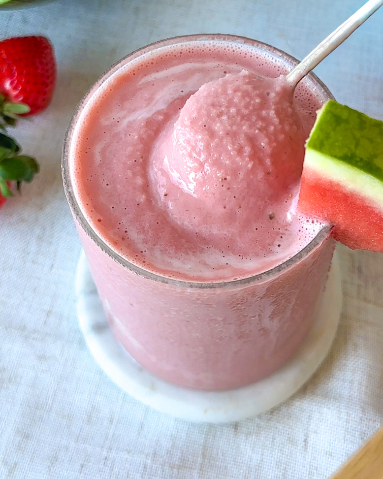 overhead image of strawberry watermelon smoothie being spooned