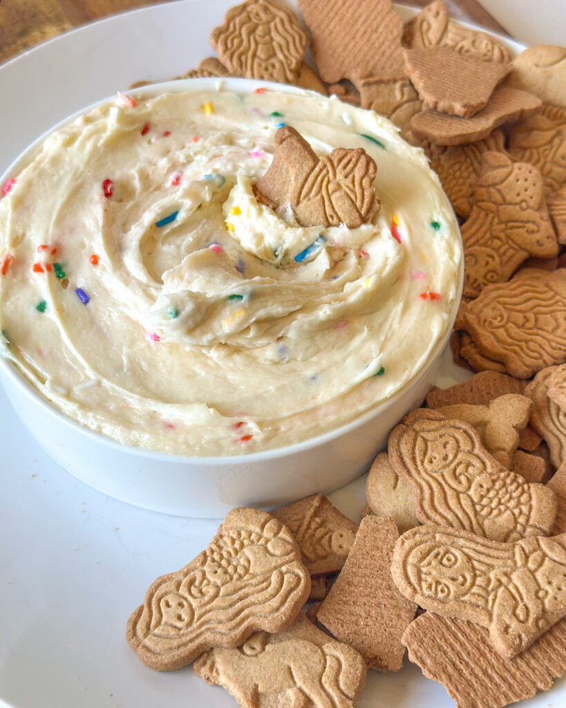 Homemade Dunkaroo dip after serving with an animal cracker in the center.