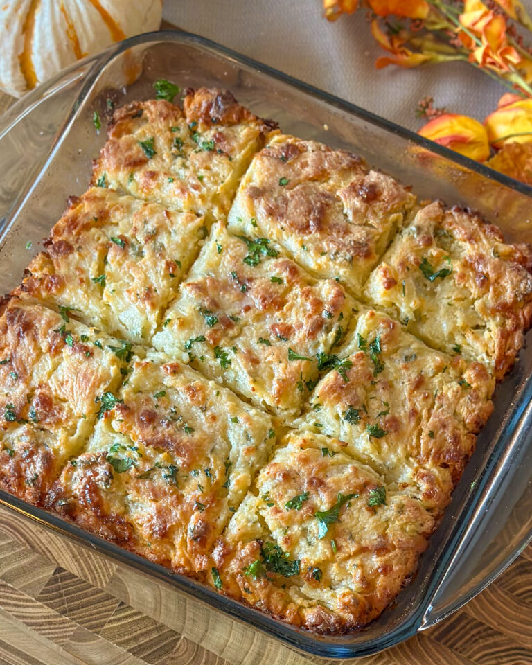 Overhead view of nine golden Cheddar Bay Biscuits scored into squares and glistening with melted butter