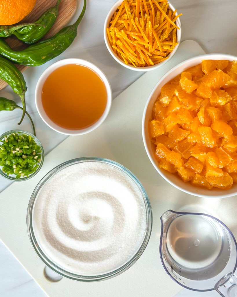 Ingredients for spicy citrus pepper jelly including chopped Sumo citrus, citrus rind, apple cider vinegar, peppers, sugar and water